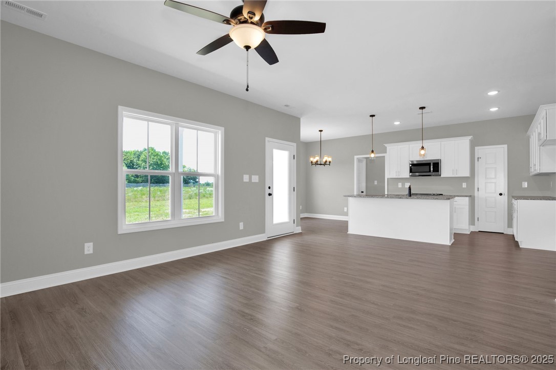 121 Merle Road Pinebluff, NC 28373 - Photo 13 of 28 a view of an empty room with kitchen and window