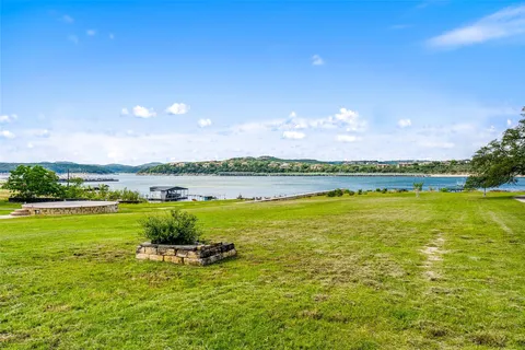 a view of a lake with houses in the back