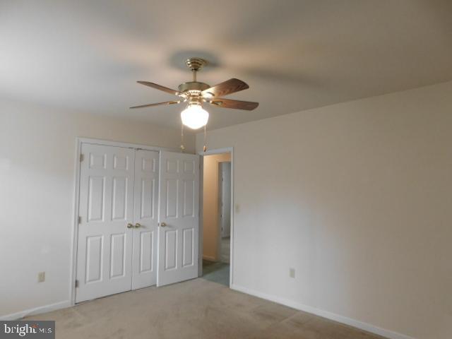 5013 Decatur Street St. Leonard, MD 20685 - Photo 27 of 45 an empty room with a chandelier fan and windows