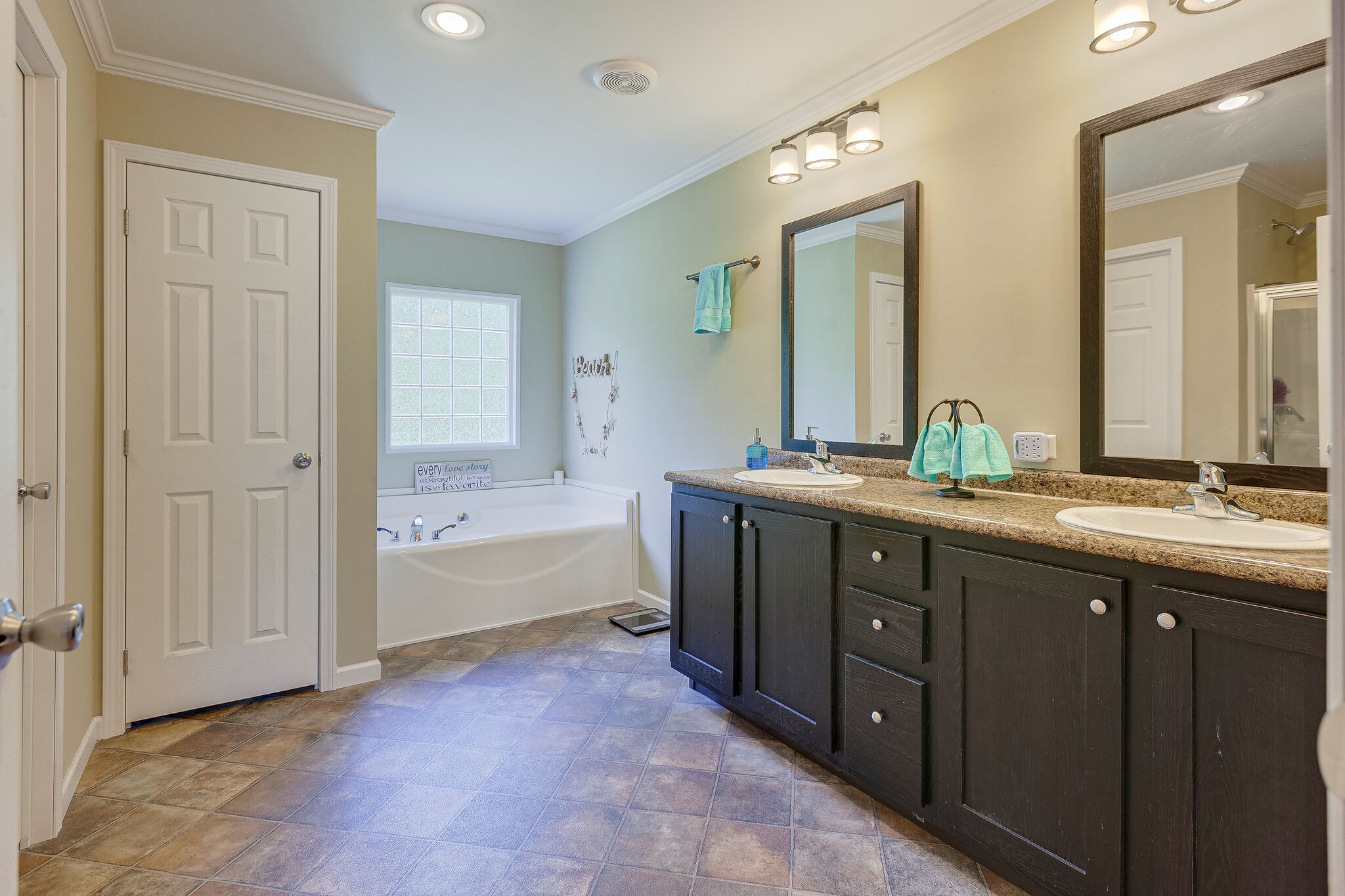 3349 Mahlon Moore Road Spring Hill, TN 37174 - Photo 18 of 28 a spacious bathroom with a double vanity sink a mirror and a bathtub