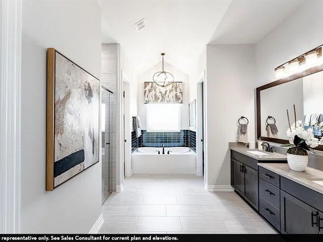 a bathroom with a tub sink and mirror