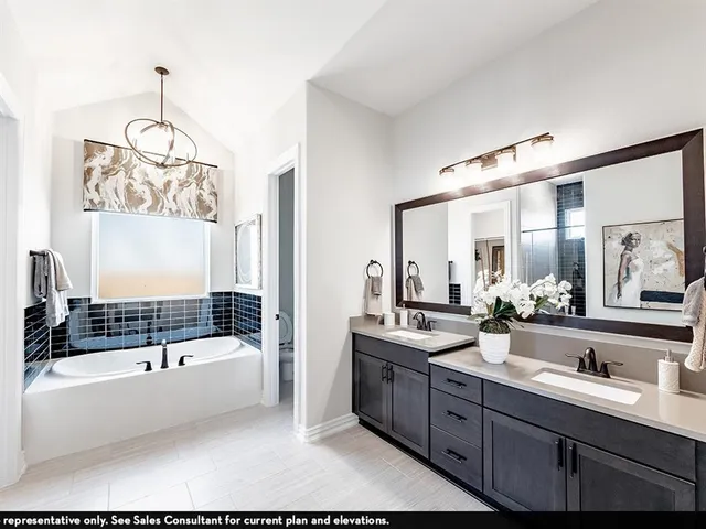a bathroom with a tub sink a mirror and shower