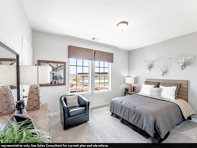 a bedroom with a bed and a couch next to a window