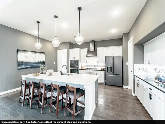 a large kitchen with a table and chairs