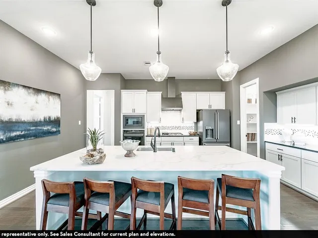 a dining room with wooden floor a chandelier a wooden table and chairs