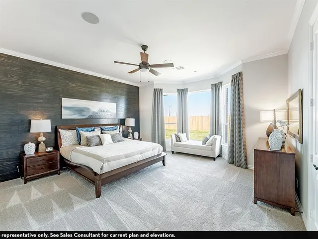 a spacious bedroom with a bed and a couch