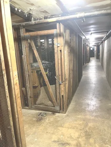 a view of a hallway with wooden floor and stairs