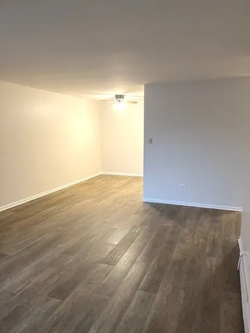 a view of an empty room and wooden floor