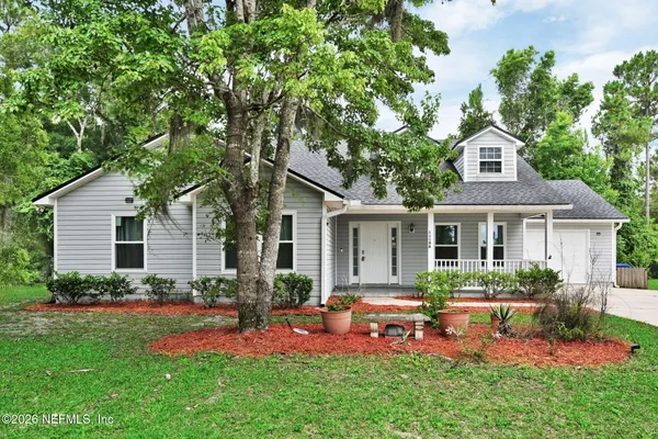 a front view of house with yard and green space