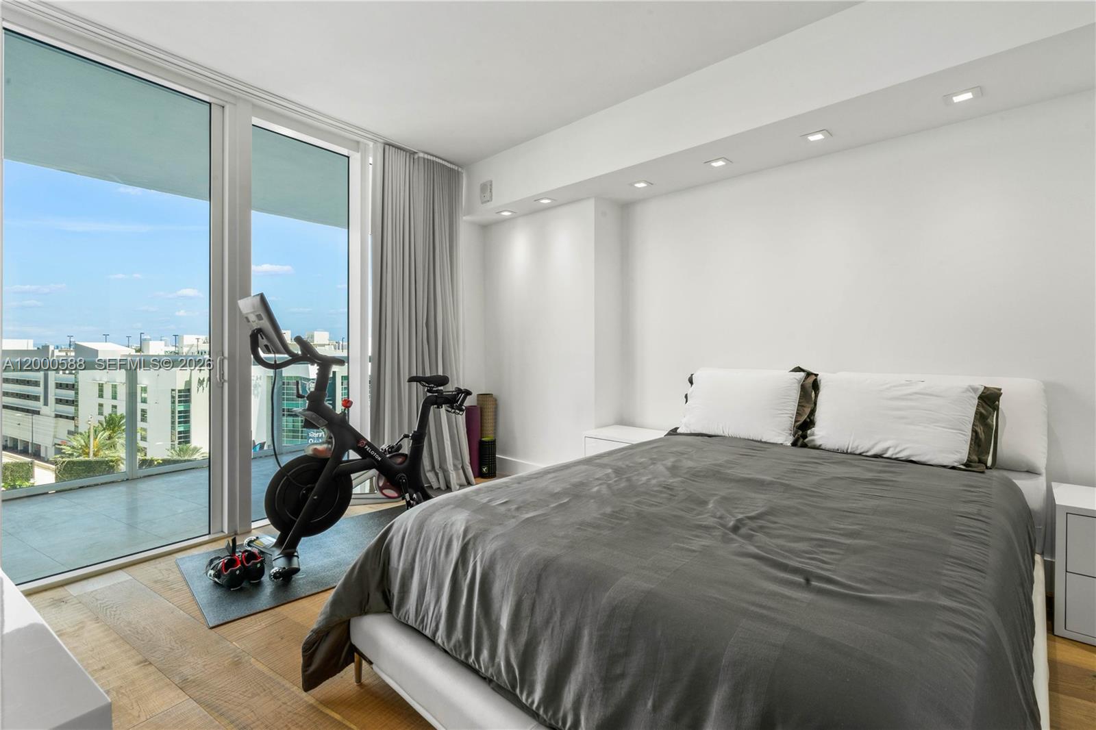 450 Alton Road, Unit 806 Miami Beach, FL 33139 - Photo 12 of 23 a bedroom with a bed and large windows