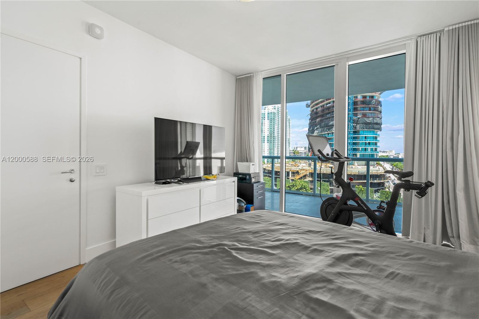 450 Alton Road, Unit 806 Miami Beach, FL 33139 - Photo 13 of 23 a bedroom with a bed and a large window