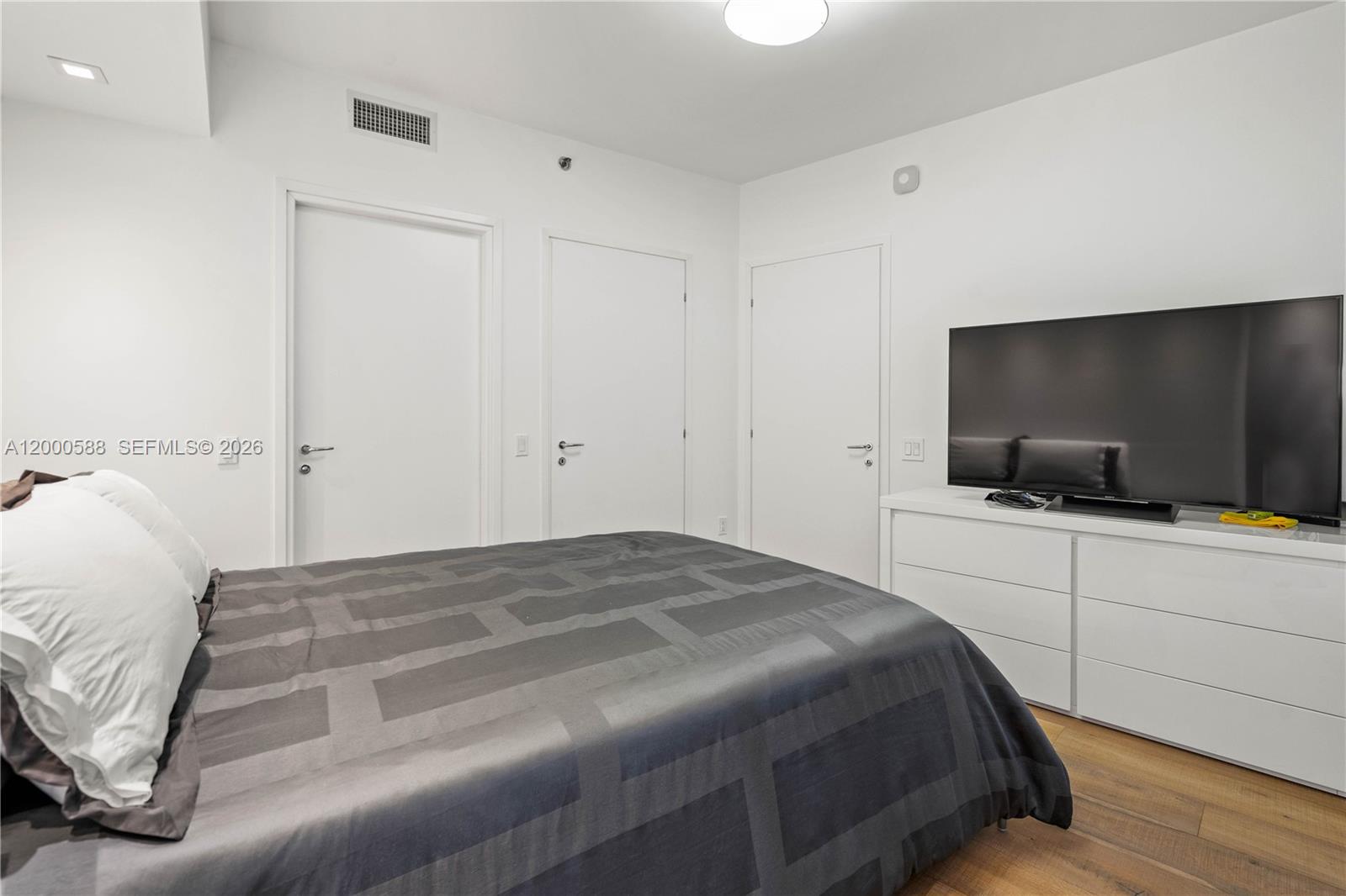 450 Alton Road, Unit 806 Miami Beach, FL 33139 - Photo 14 of 23 a bedroom with a bed and a flat screen tv