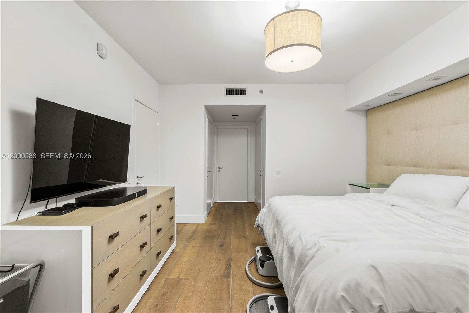 450 Alton Road, Unit 806 Miami Beach, FL 33139 - Photo 18 of 23 a bedroom with a bed and flat screen tv