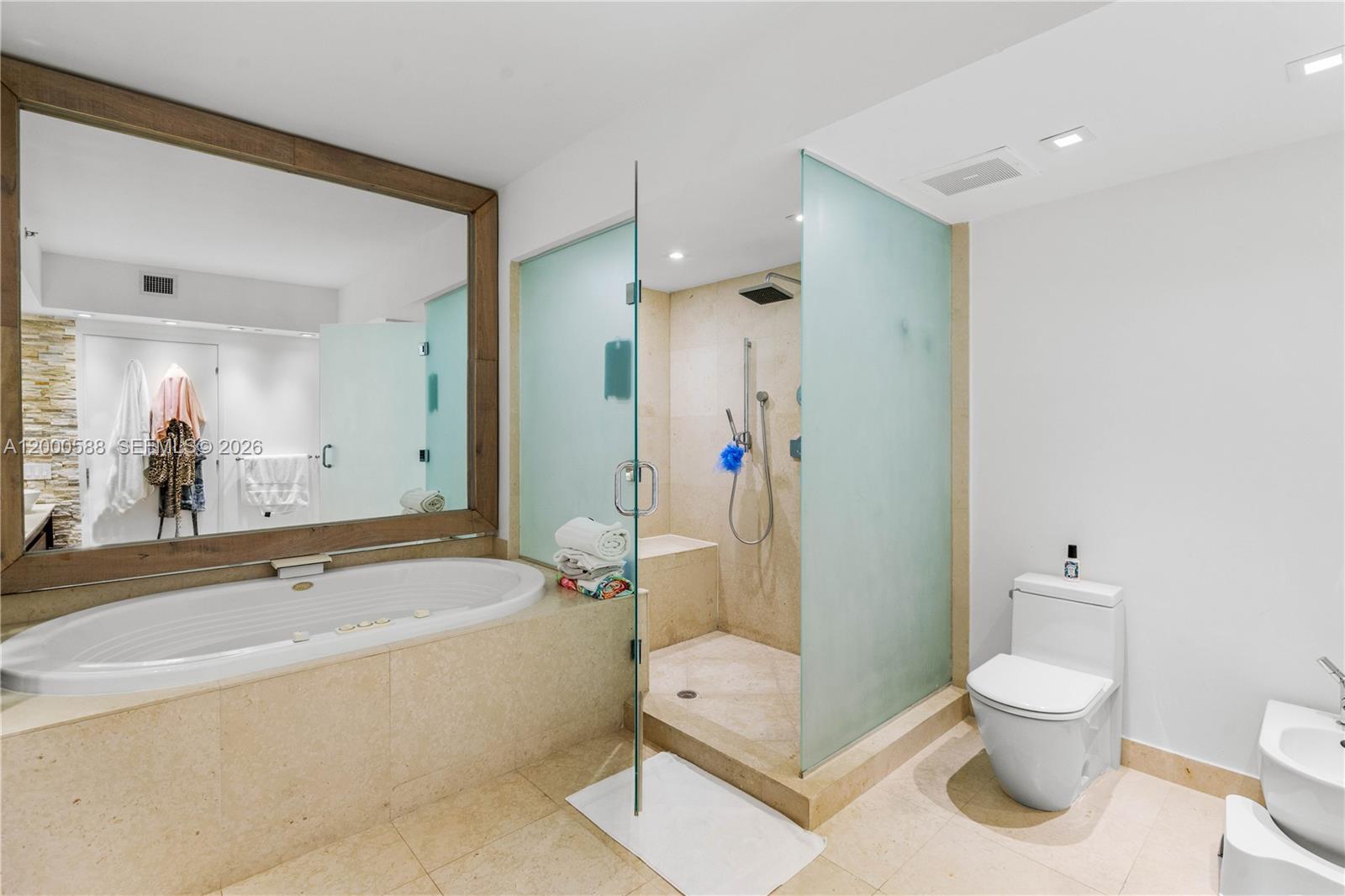 450 Alton Road, Unit 806 Miami Beach, FL 33139 - Photo 19 of 23 a bathroom with a granite countertop toilet a sink and a bathtub