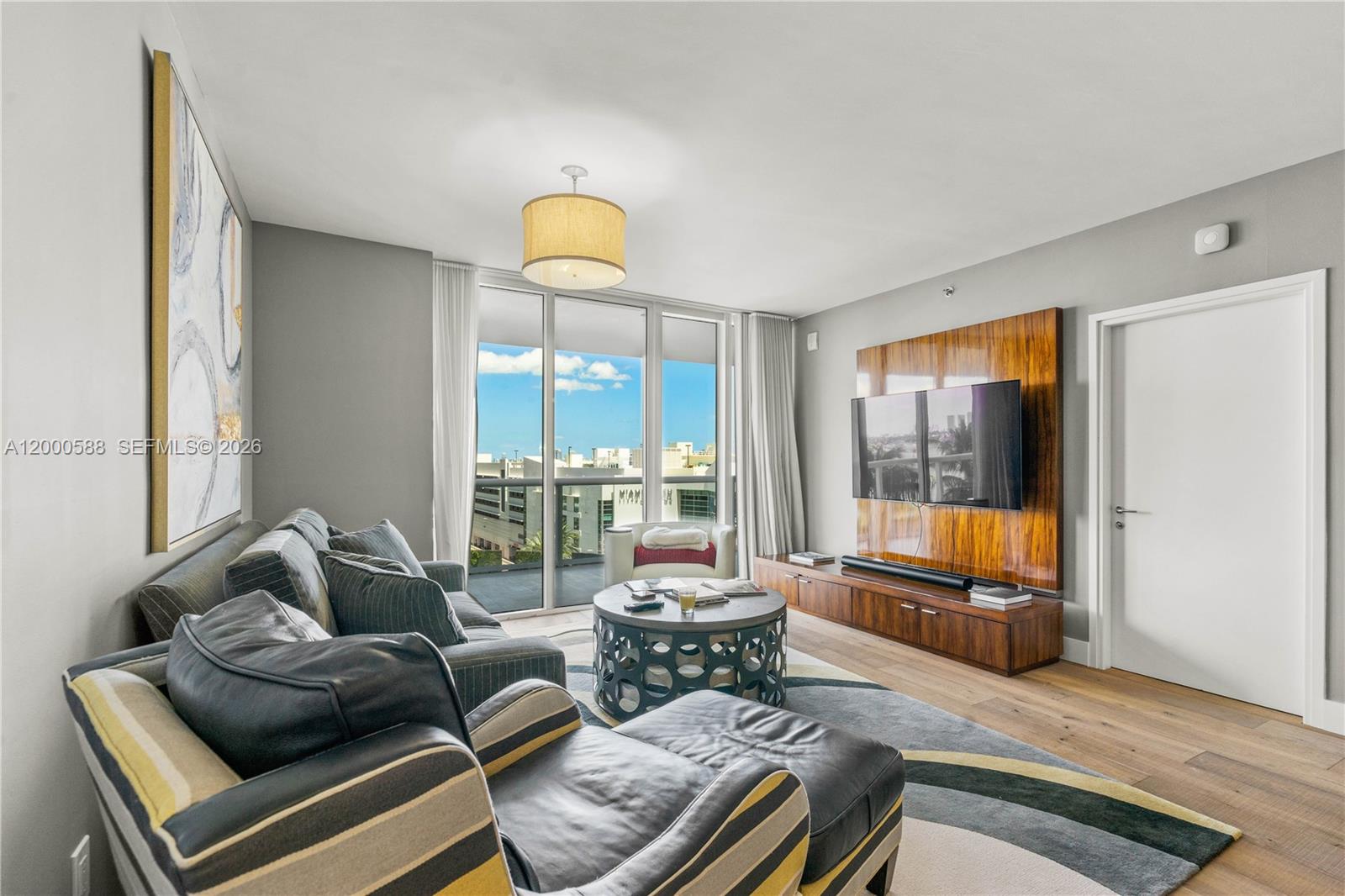 450 Alton Road, Unit 806 Miami Beach, FL 33139 - Photo 5 of 23 a living room with furniture and a large window