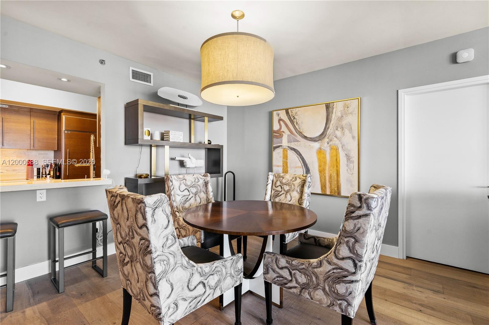 450 Alton Road, Unit 806 Miami Beach, FL 33139 - Photo 8 of 23 a view of a dining room with furniture and wooden floor