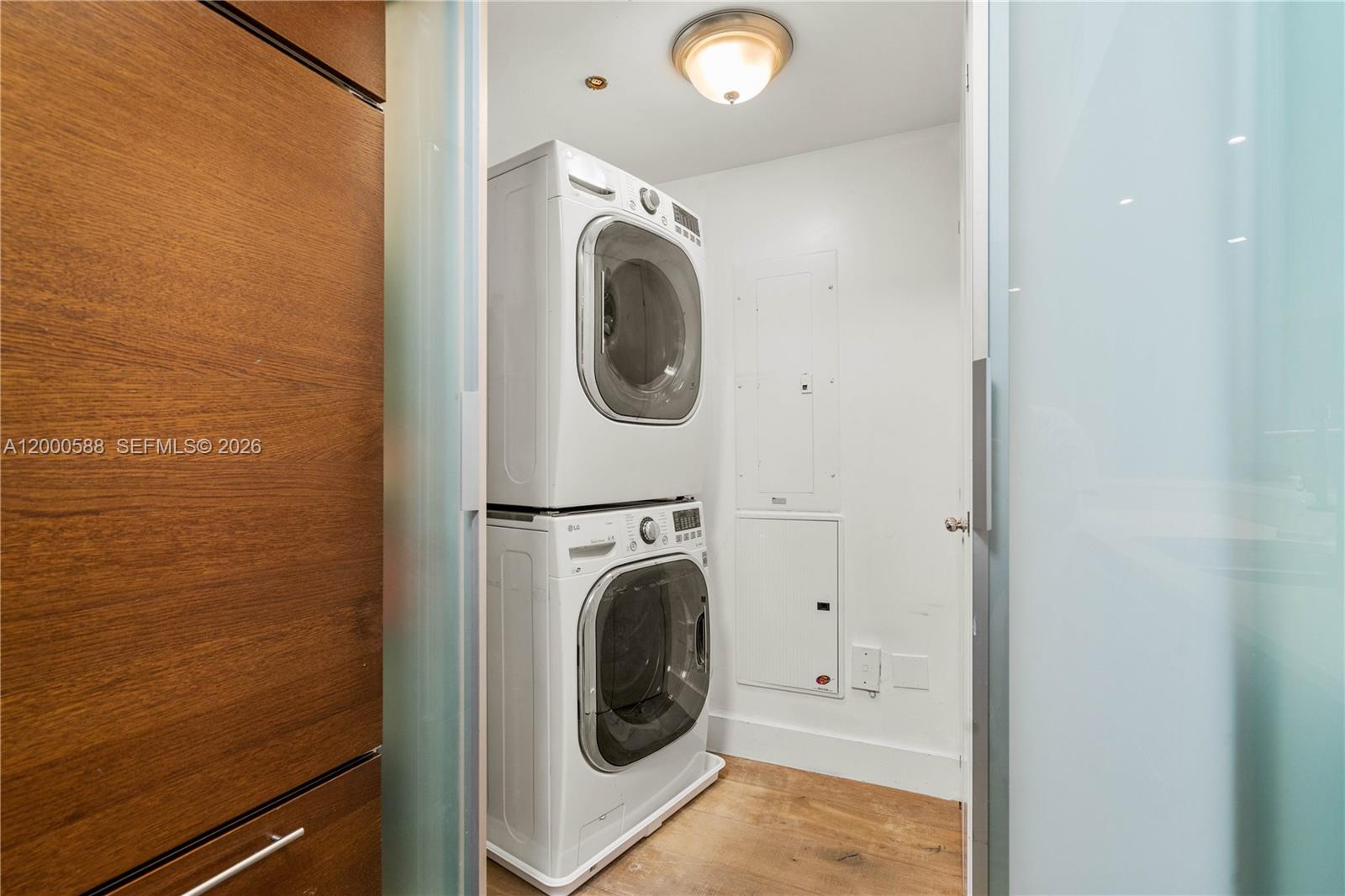 450 Alton Road, Unit 806 Miami Beach, FL 33139 - Photo 9 of 23 a view of a hallway with washer and dryer