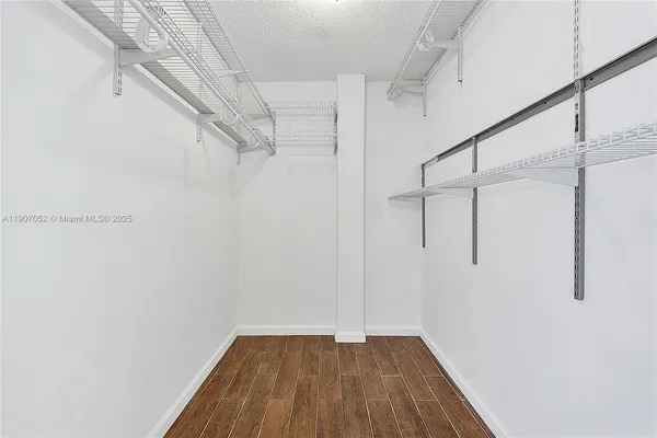a view of a balcony with floor to ceiling windows with wooden floor