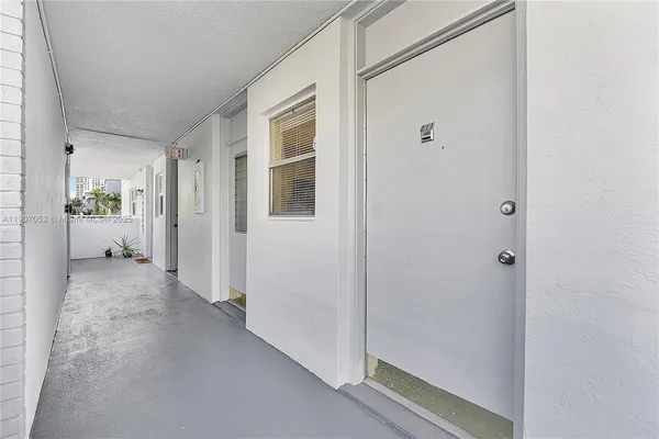 a view of an entryway with wooden floor and windows
