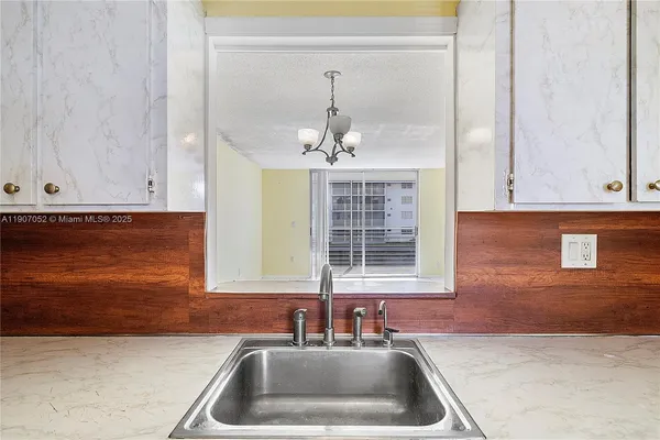 a view of empty room with wooden floor and cabinet