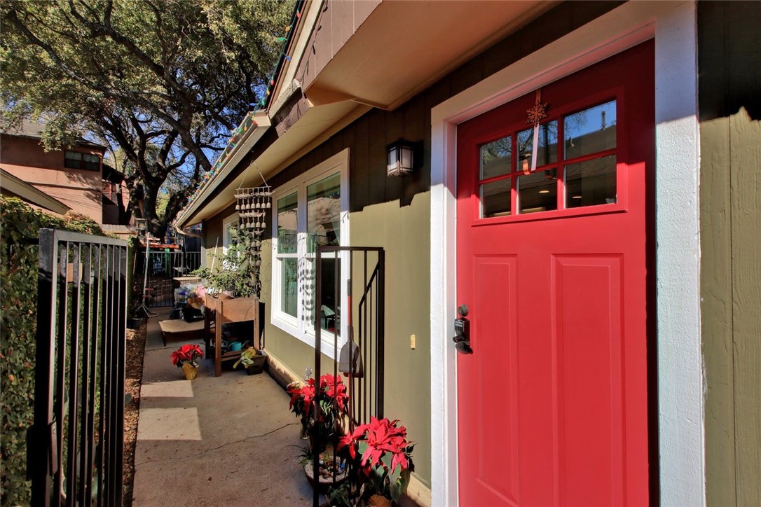 a view of a house with a potted plant and a garage
