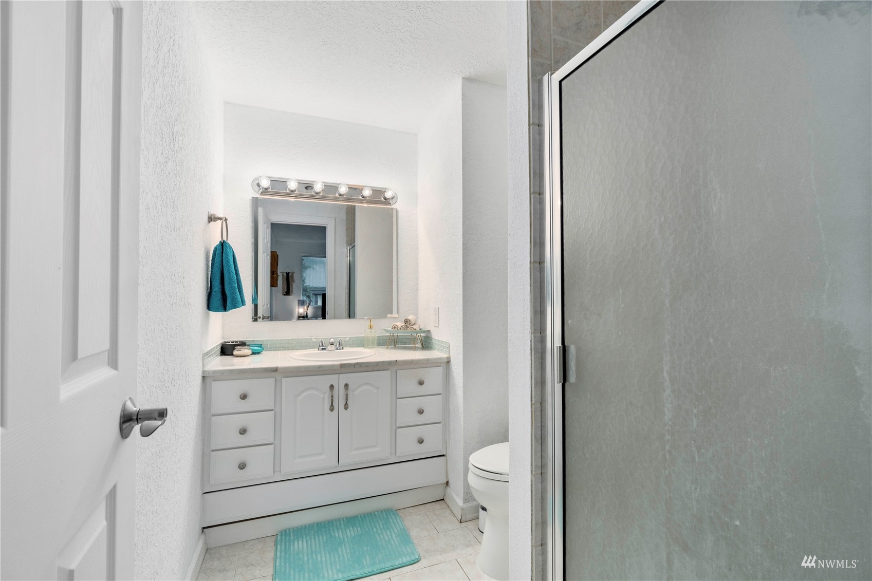 1800 Grant Avenue South, Unit D2 Renton, WA 98055 - Photo 17 of 23 a bathroom with a granite countertop sink mirror vanity and toilet