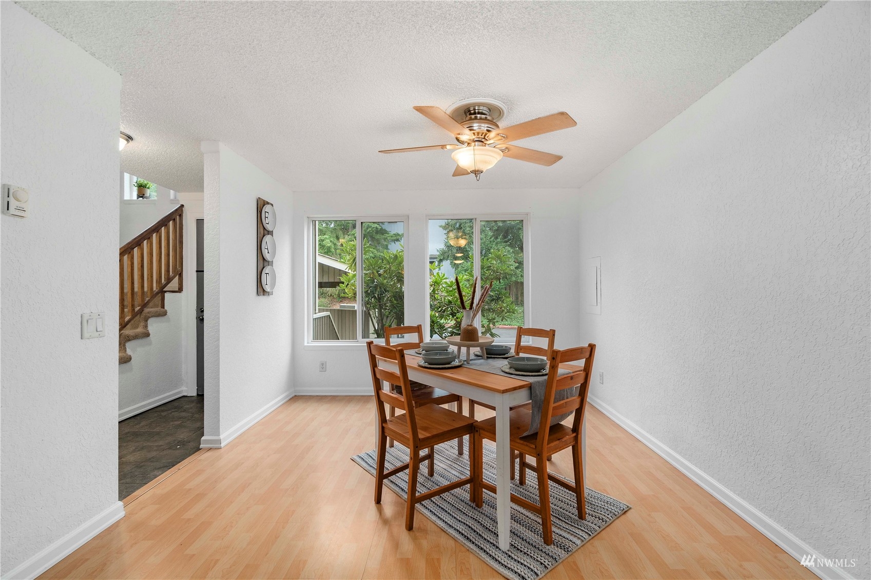 1800 Grant Avenue South, Unit D2 Renton, WA 98055 - Photo 7 of 23 a dining room with furniture a chandelier and wooden floor