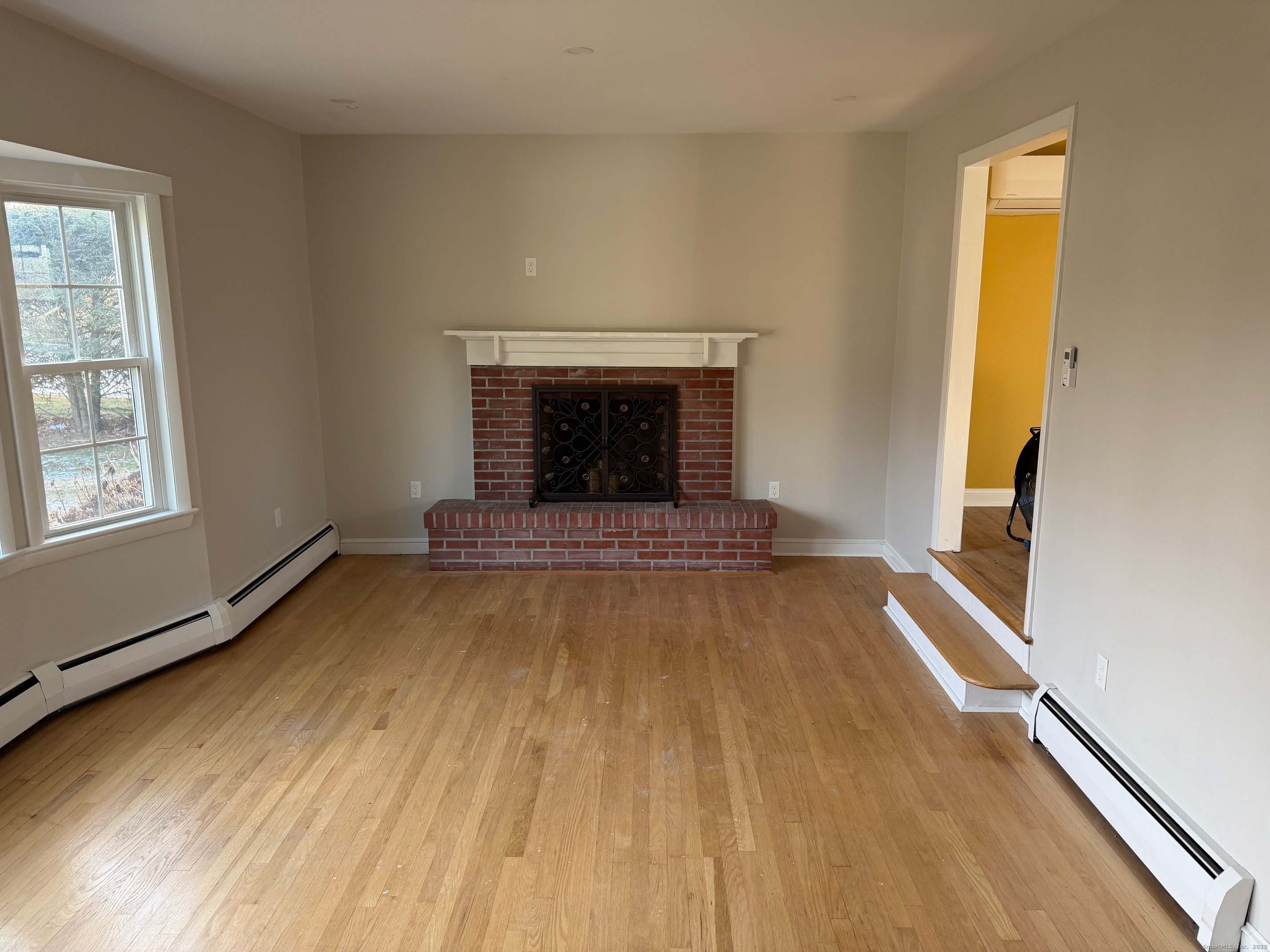 36 Colonial Drive Prospect, CT 06712 - Photo 3 of 18 a view of an empty room with wooden floor and a window