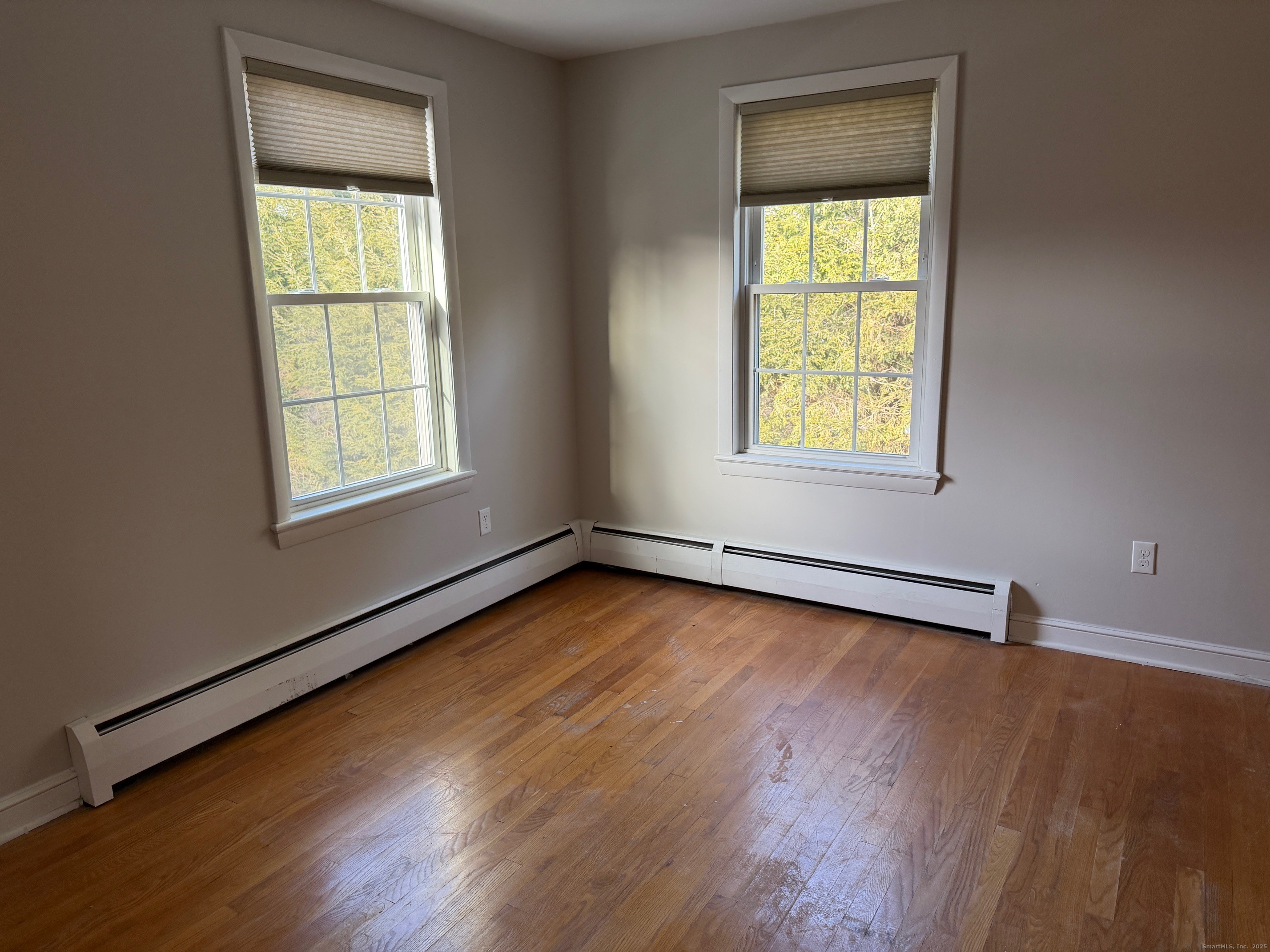 36 Colonial Drive Prospect, CT 06712 - Photo 8 of 18 an empty room with wooden floor and windows