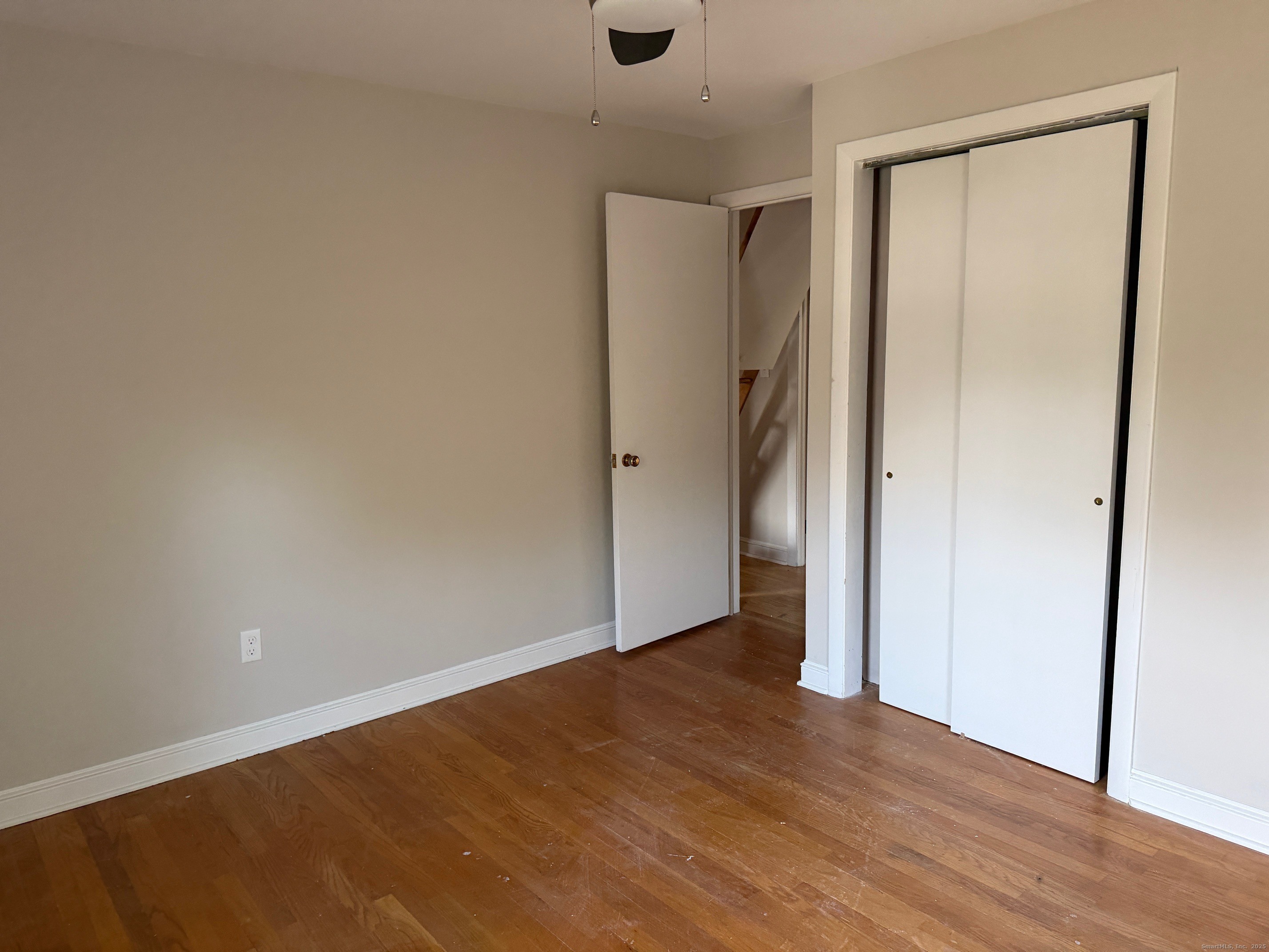 36 Colonial Drive Prospect, CT 06712 - Photo 10 of 18 an empty room with wooden floor and a ceiling fan
