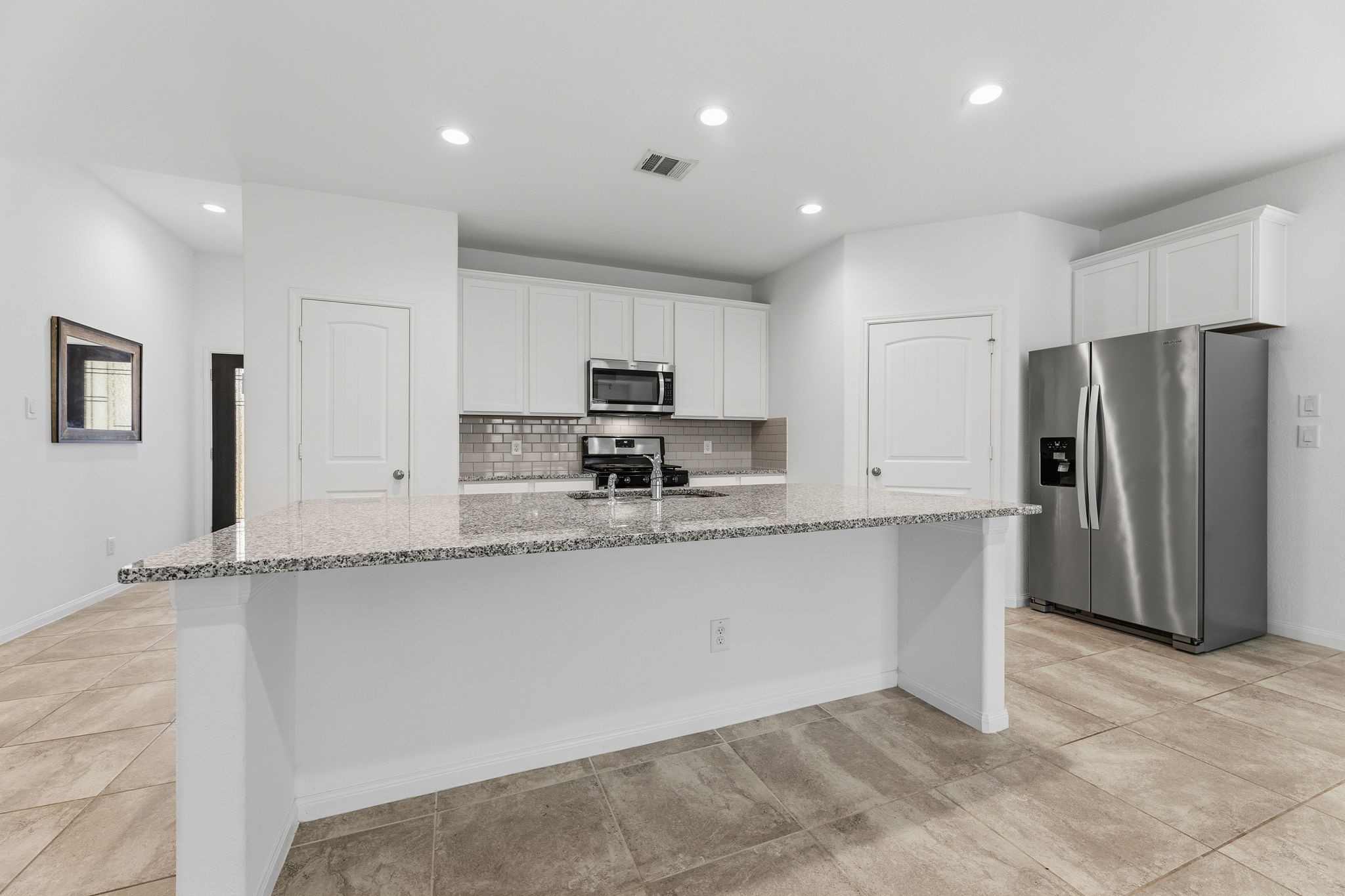 17515 Harbourfront Road Humble, TX 77346 - Photo 10 of 36 Kitchen with Granite Counters and Breakfast Bar