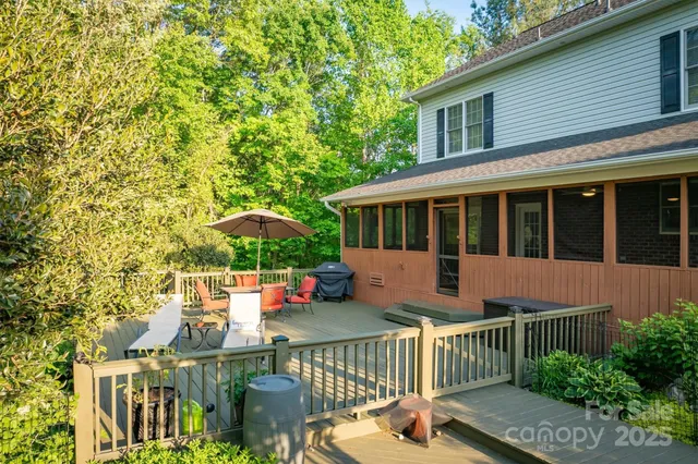 a view of a house with wooden deck and furniture