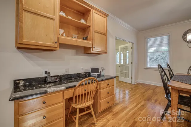 a kitchen with stainless steel appliances granite countertop a sink a stove and cabinets