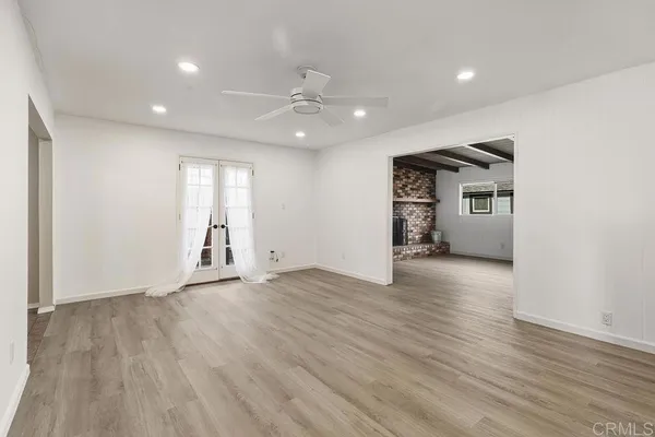 a view of empty room with wooden floor