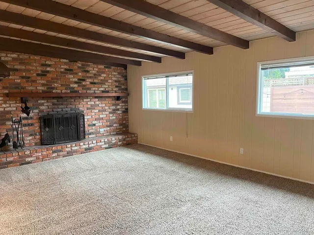 a view of empty room with a fireplace