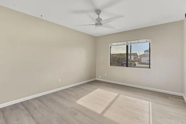 a bedroom with a bed and a large mirror with a flat tv screen