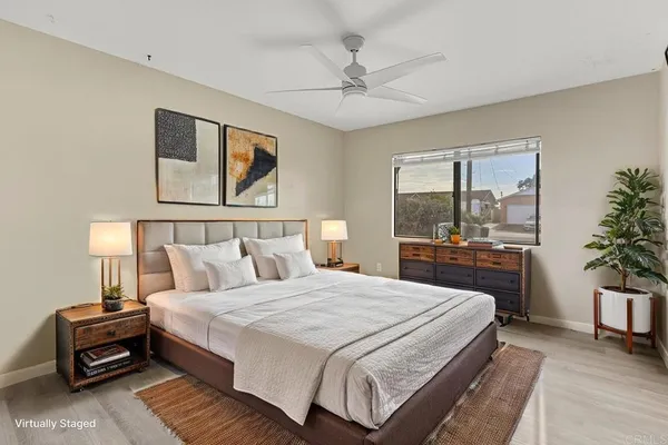 a view of a livingroom with wooden floor and a bathroom