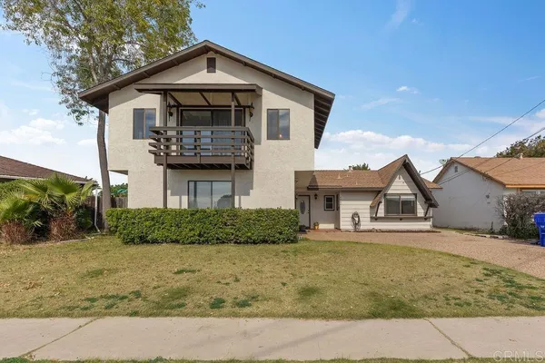 a living room with furniture a rug and white walls