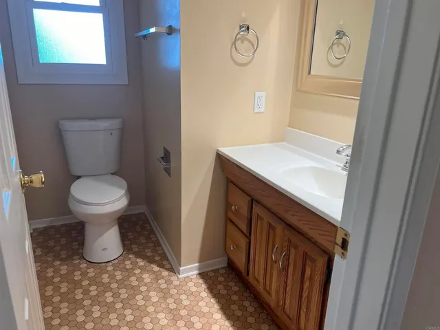a bathroom with a sink a toilet and mirror