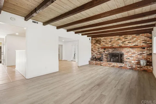 a living room with furniture a rug and a table