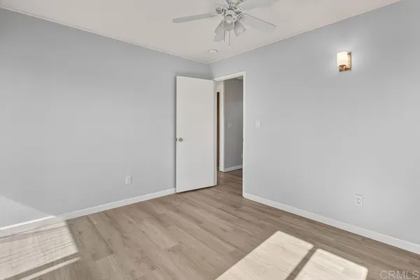a bathroom with a granite countertop bathtub shower and toilet
