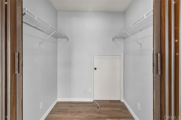 a view of a hallway with wooden floor