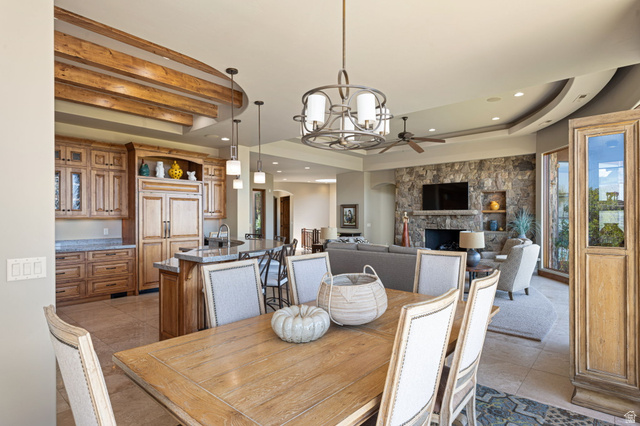 2331 West Entrada Trail, Unit 61 St. George, UT 84770 - Photo 14 of 69 Spacious open-concept interior featuring a gourmet kitchen, natural wood cabinetry, central island with seating, a stone-faced fireplace, and recessed ceiling lighting