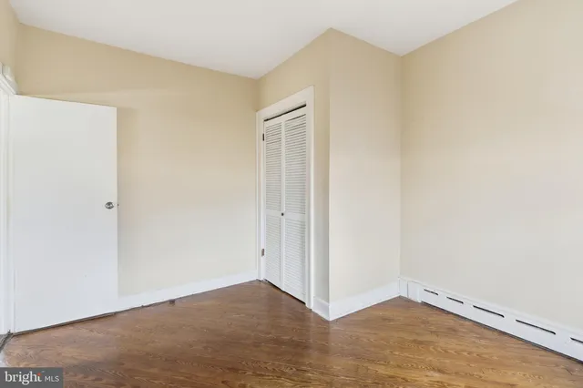 an empty room with wooden floor