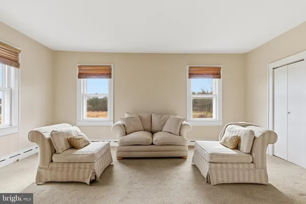 a bedroom with bed couch and window