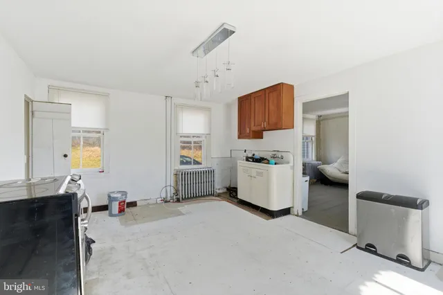 a view of kitchen with cabinets and window