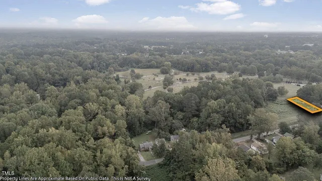 an aerial view of house with yard and mountain view in back