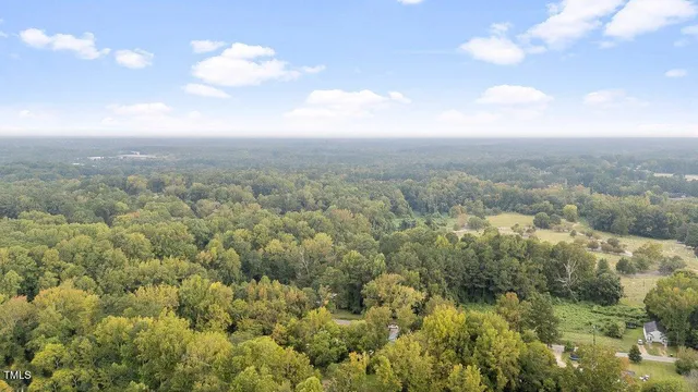 an aerial view of residential houses with city view