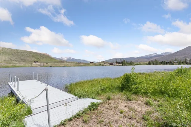 a view of a lake with houses in the back