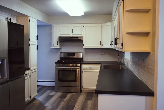 a kitchen with stainless steel appliances a sink stove and refrigerator